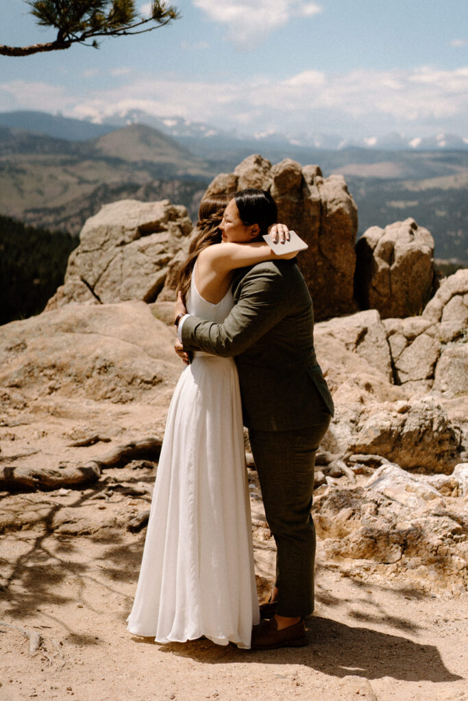 Couple hugging during vows on wedding day at Sunrise Amphitheater 