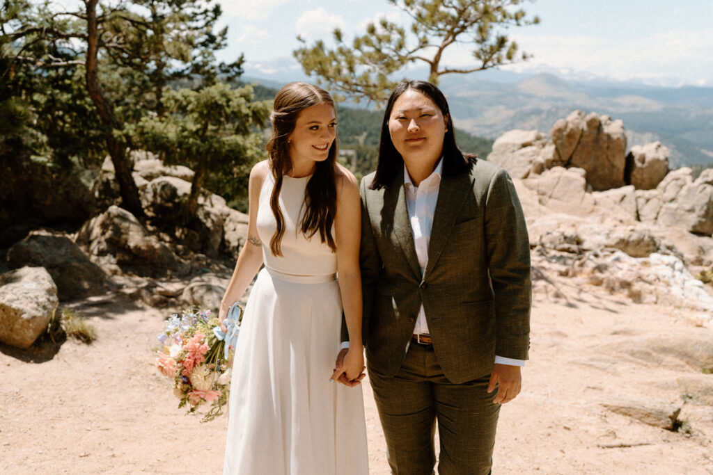 Couple smiling and walking on trail during wedding day