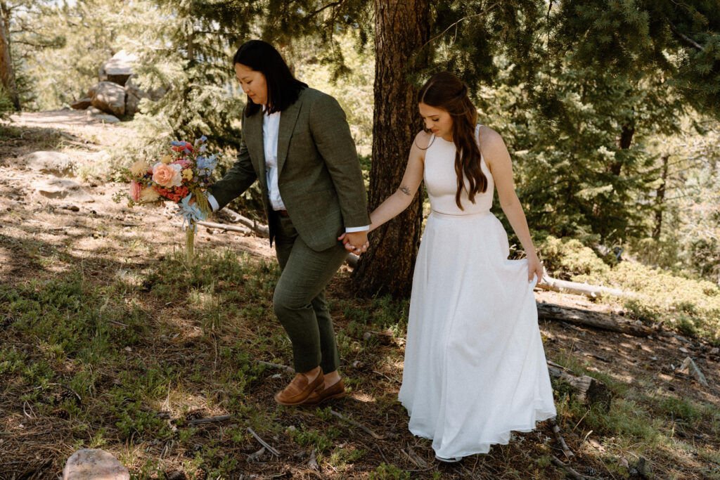 Couple walking up hill on wedding day