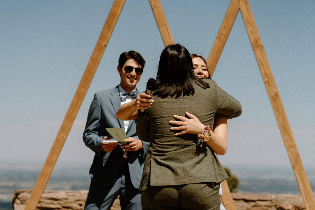 Bride hugging wedding party at Sunrise Amphitheater 