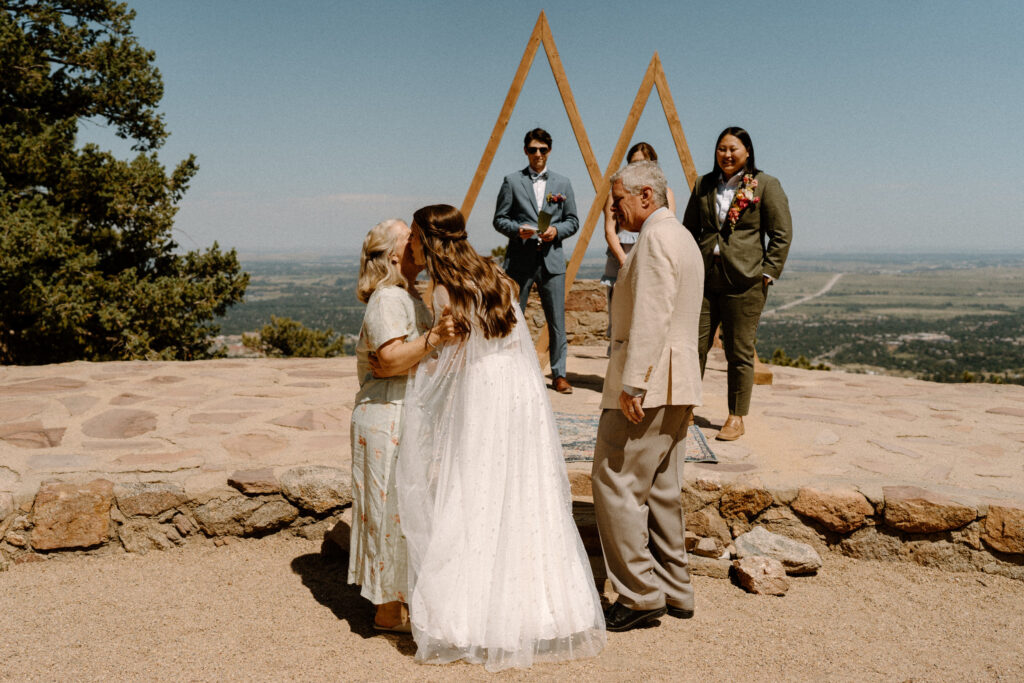 Bride kissing mom on wedding day at Sunrise Amphitheater 