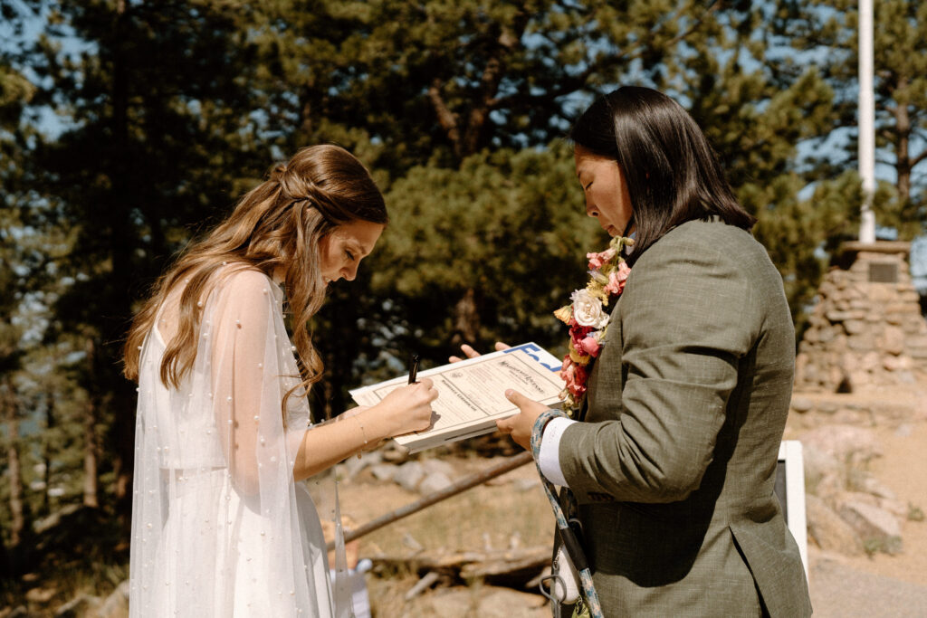 Bride signing marriage license on wedding day at Sunrise Amphitheater 
