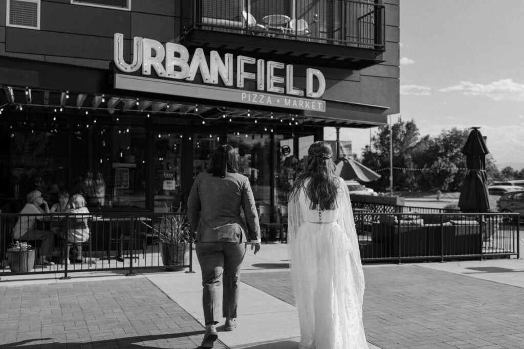 Couple walking into Urban Field on wedding day