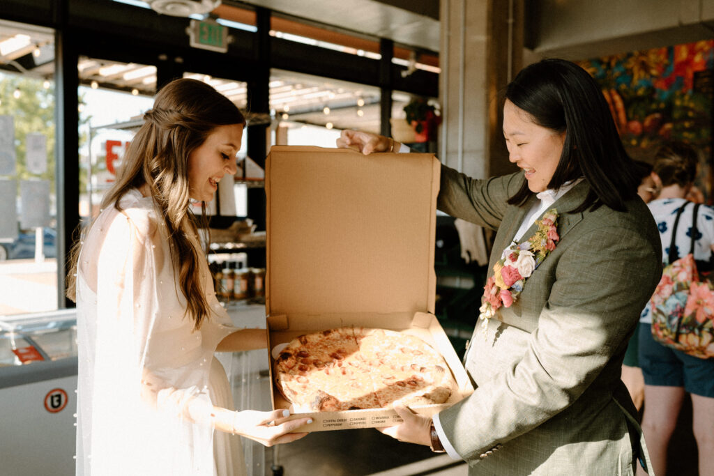 Couple picking up pizza on wedding day at Urban Field