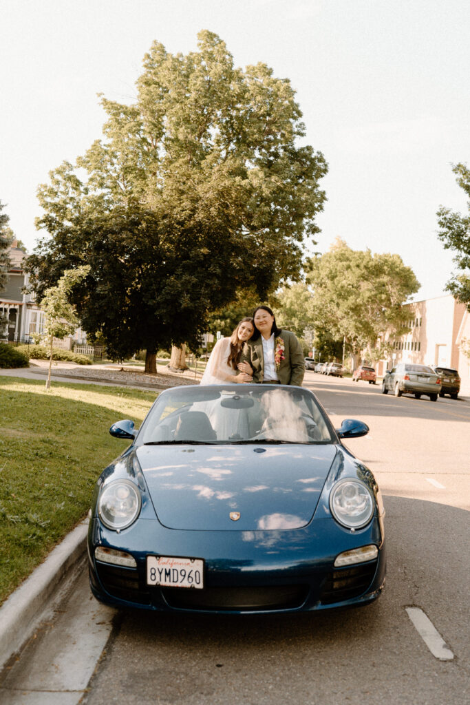 Couple smiling inside car on wedding day