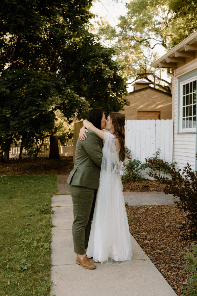 Couple kissing on walking path on wedding day