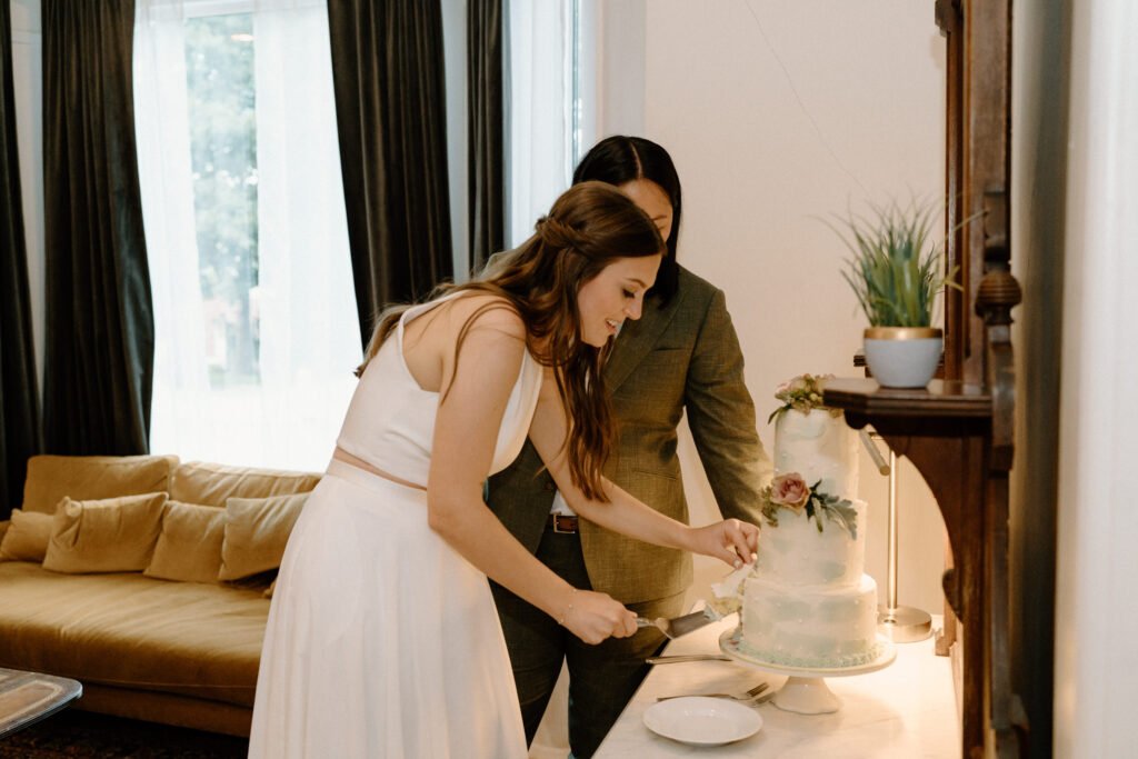 Couple cutting cake during wedding reception