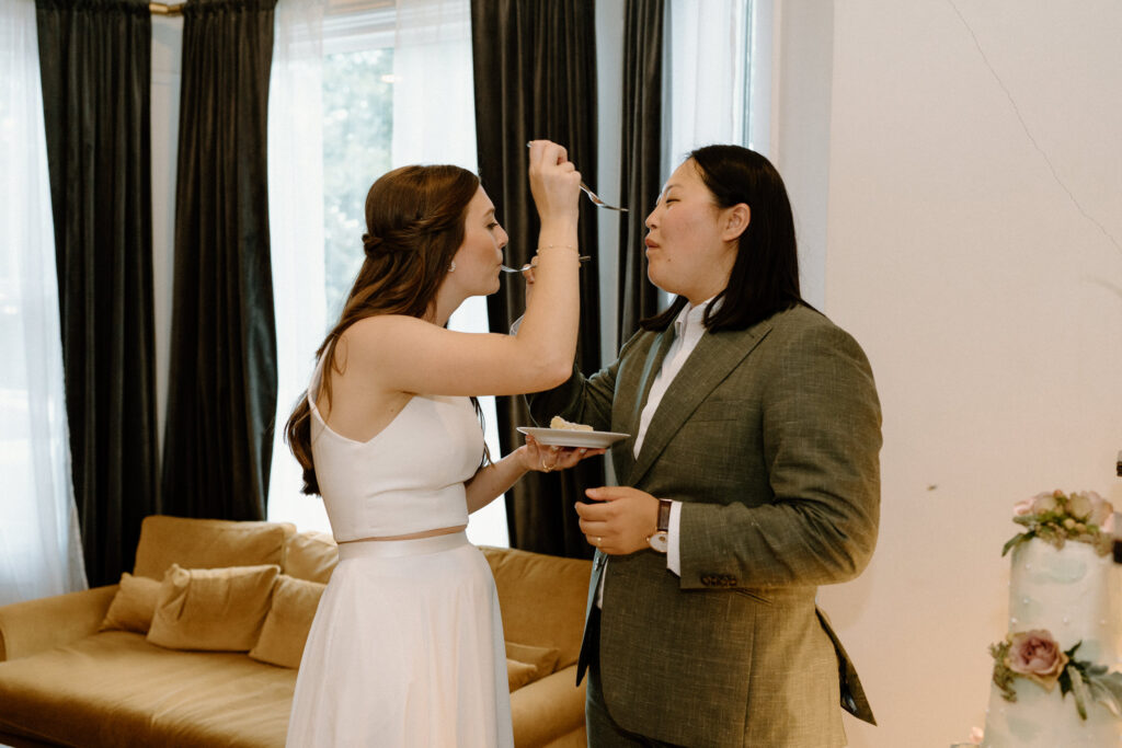 Couple feeding each other cake from a wedding reception 