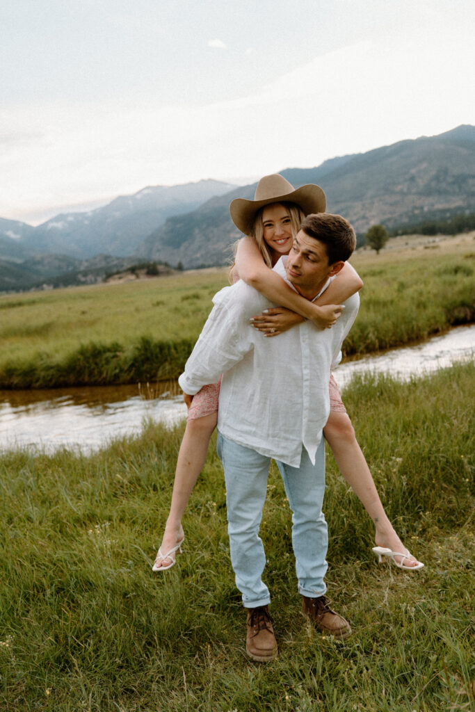 Fiancée laughing on fiancés back during engagement session at Rocky Mountain National Park