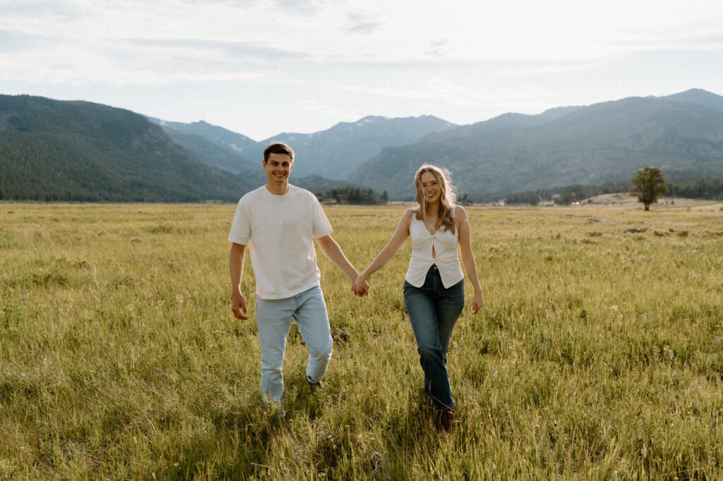 Couple holding hands during an engagement session at Rocky Mountain National Park