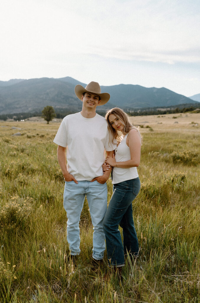Couple smiling at camera during an engagement session at Rocky Mountain National Park