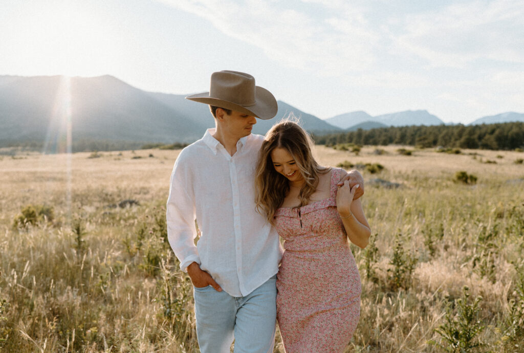 Couple laughing while hiking at Rocky Mountain National Park during an engagement session