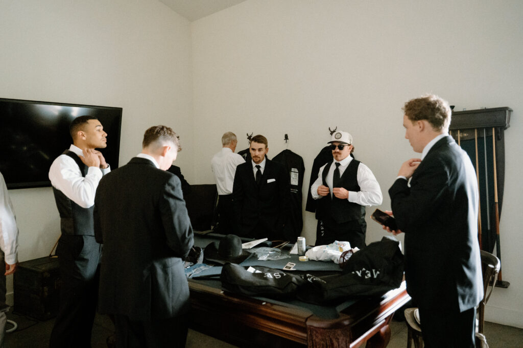 Groomsmen getting ready on wedding day at Woodlands