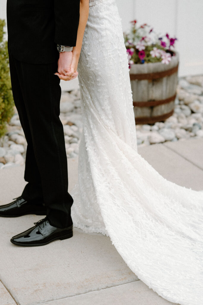 Bride and groom holding hands during first touch on wedding day at Woodlands