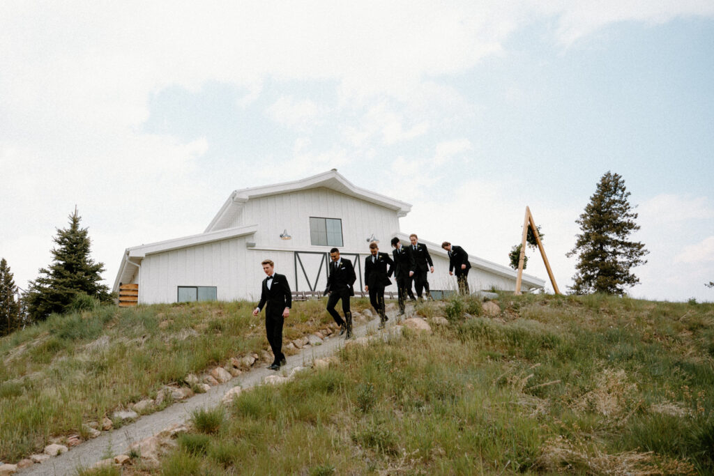 Groomsmen walking to take photos on wedding day at Woodlands