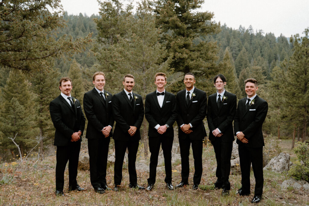 Groom and groomsmen smiling on wedding day at Woodlands