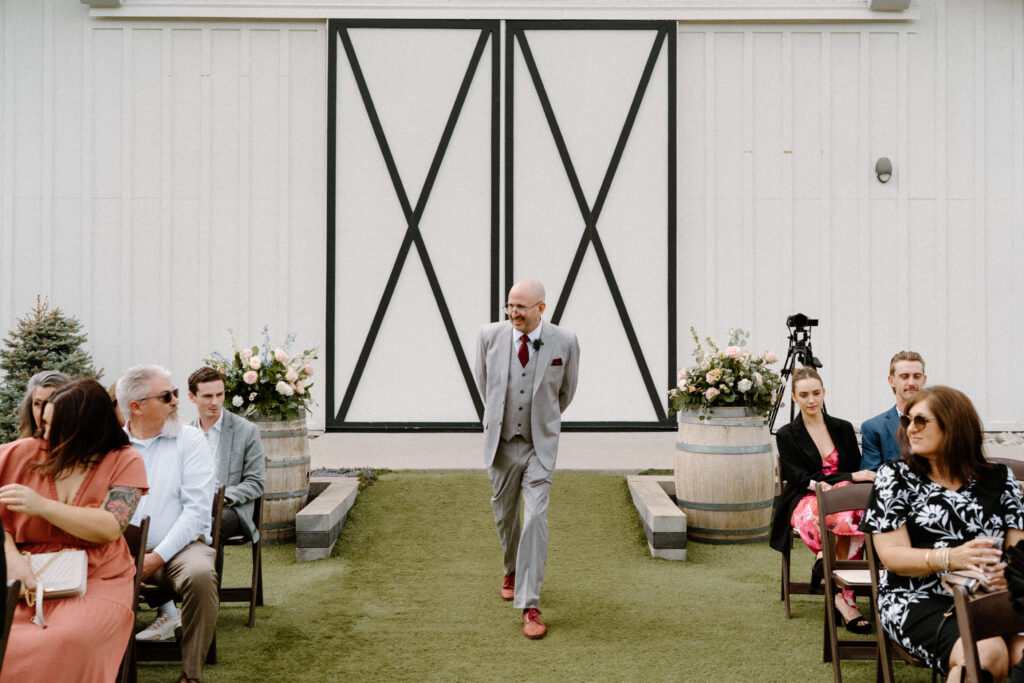 Wedding officiant walking down the aisle at Woodlands