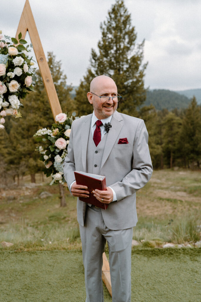 Officiant smiling at the alter on wedding day at Woodlands