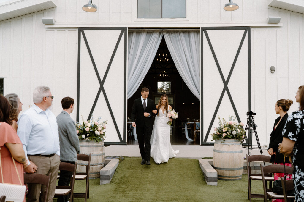 Bride and dad walking down the aisle on wedding day at Woodlands