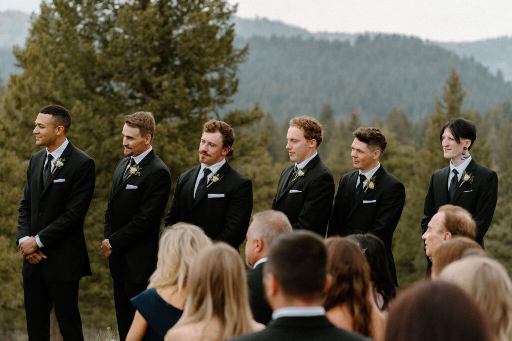 Groomsmen smiling during wedding ceremony at Woodlands