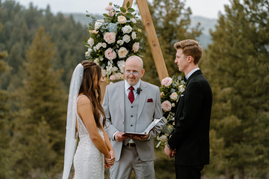 Bride and groom standing at the alter during a ceremony at Woodlands