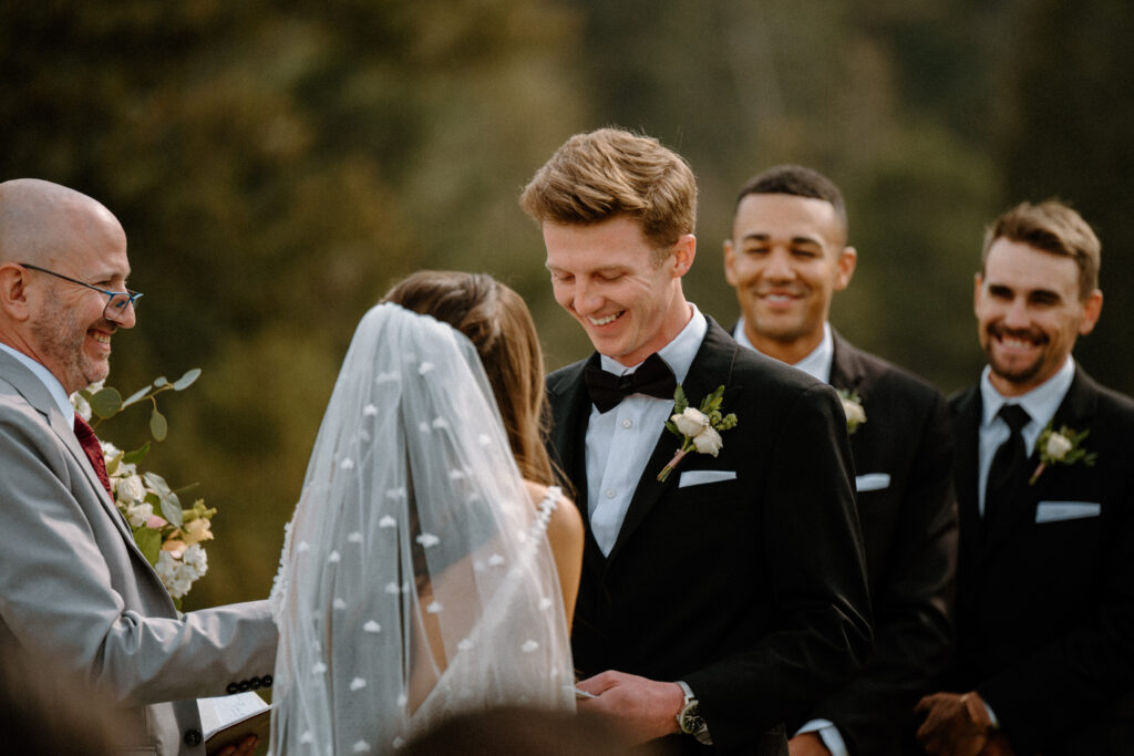 Groom smiling at the alter on wedding day at Woodlands