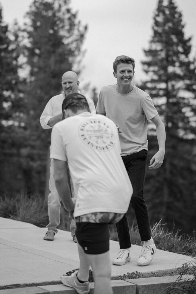 Groom smiling while hanging out with groomsmen on wedding day at Woodlands