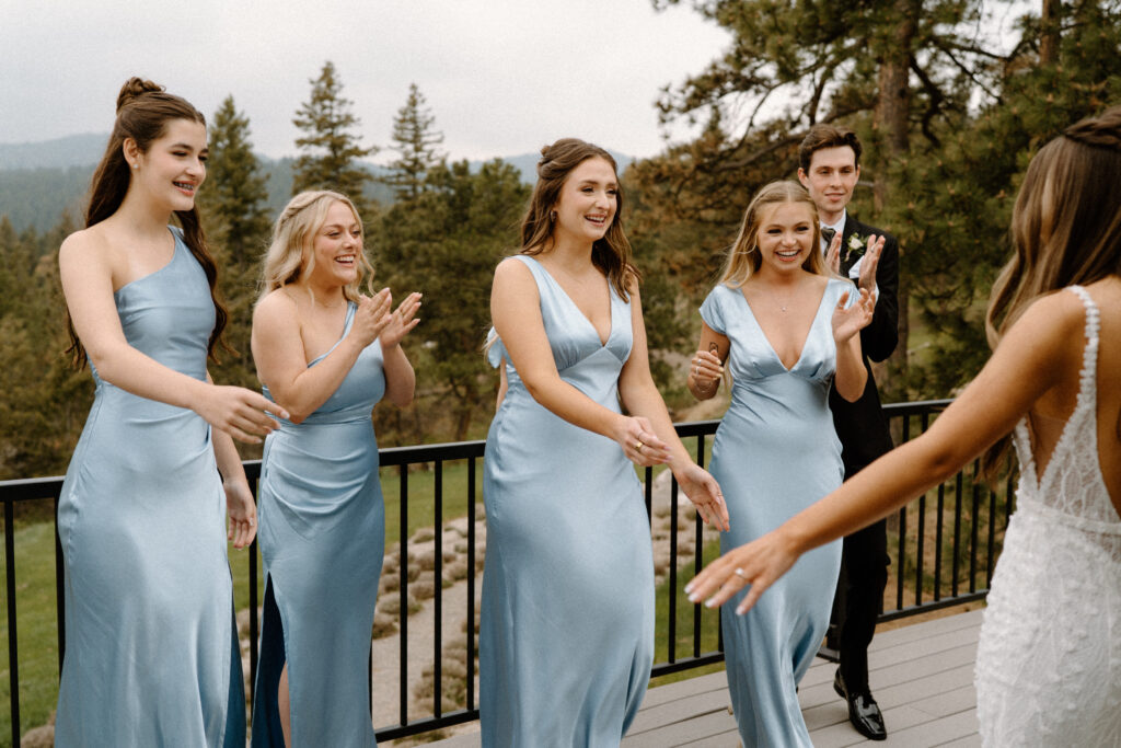 Bridal party cheering while seeing bride ready on wedding day at Woodlands