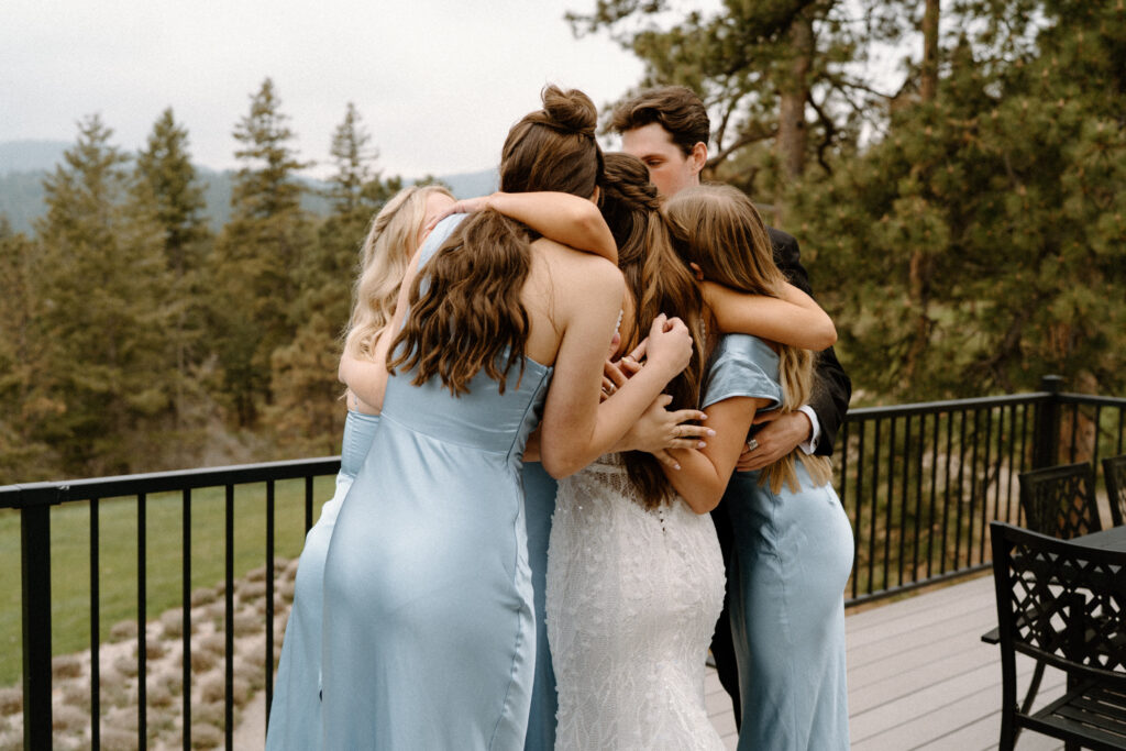 Bridal party hugging on wedding day at Woodlands