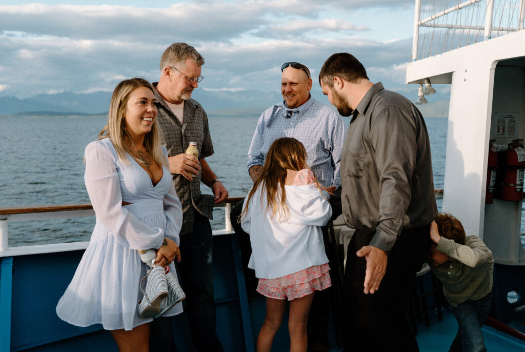 Wedding guests laughing during a rehearsal dinner in Montana