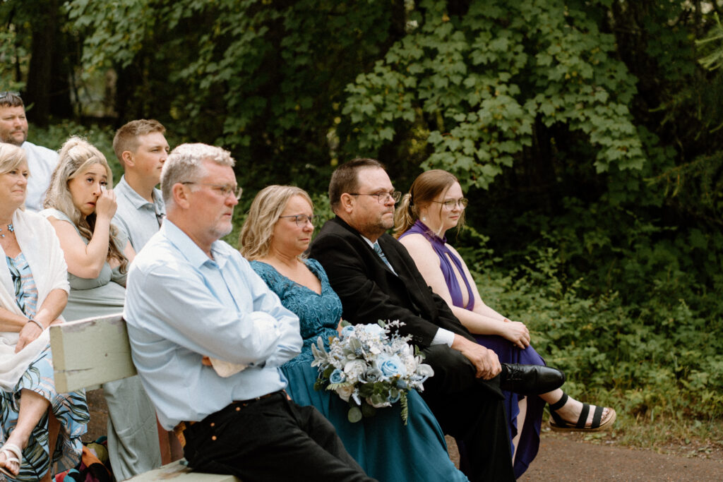 Wedding guests watching an elopement at Glacier National Park