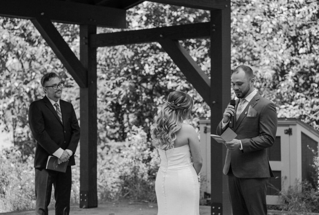 Groom reading vows during an elopement at Glacier National Park