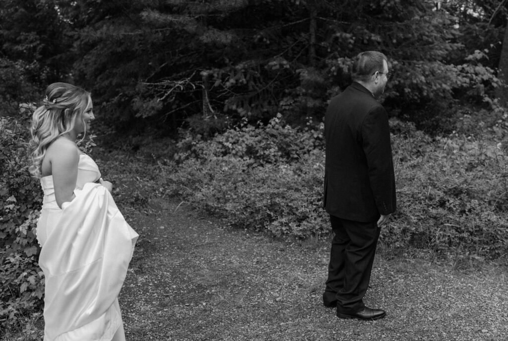 Bride walking to dad to do first look during an elopement at Glacier National Park