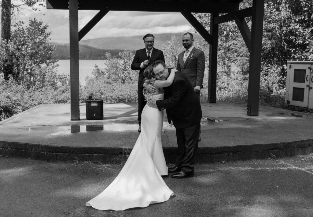 Bride hugging dad at the altering during an elopement at Glacier National Park