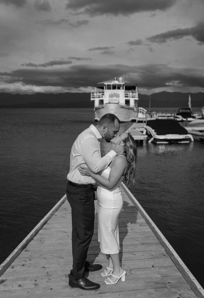 Bride and groom kissing on a dock during their rehearsal dinner in Montana