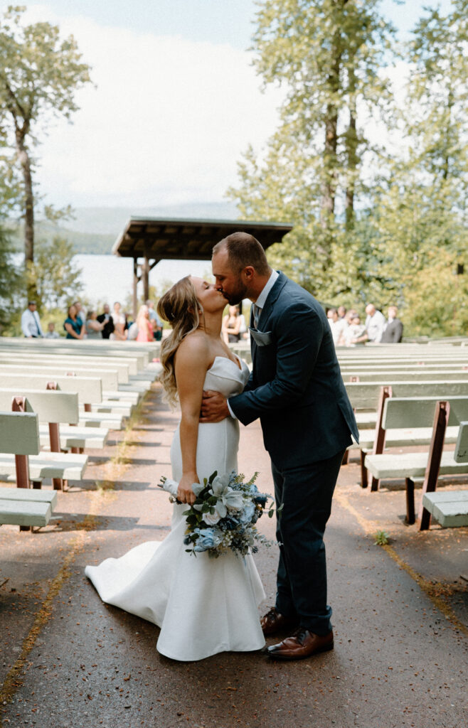 Bride and groom kissing after ceremony during an elopement at Glacier National Park