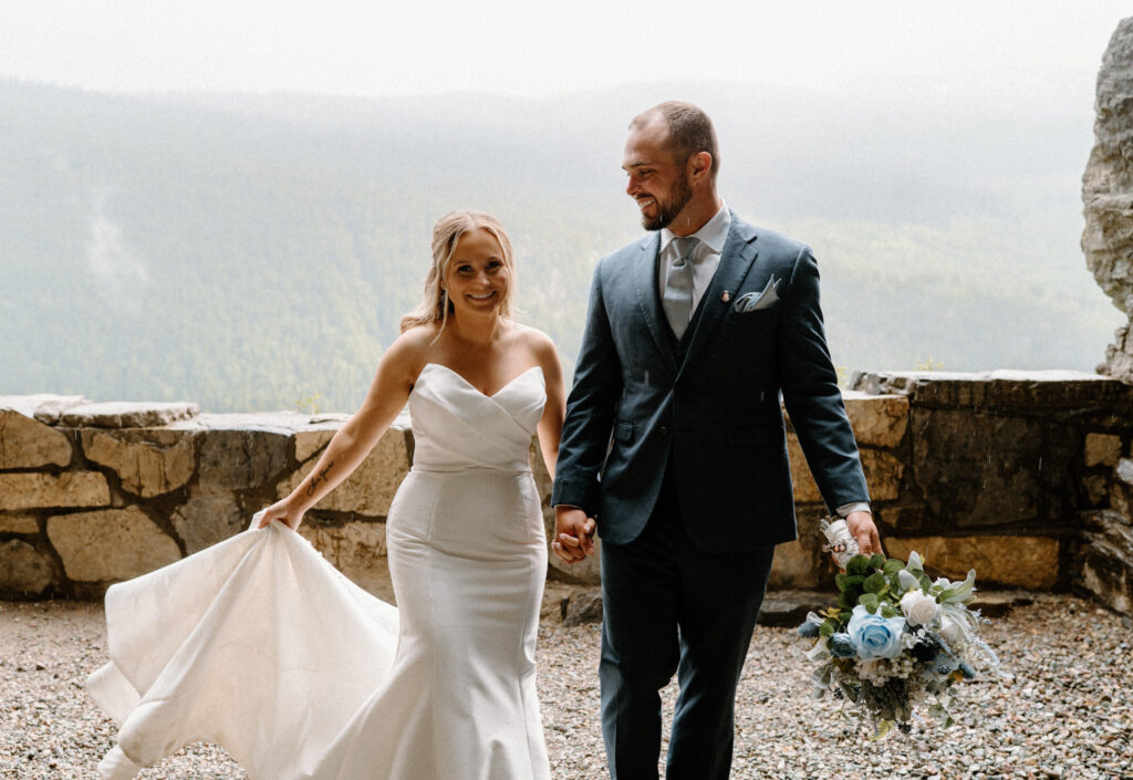 Bride and groom walking in a tunnel at Glacier National Park during an elopement