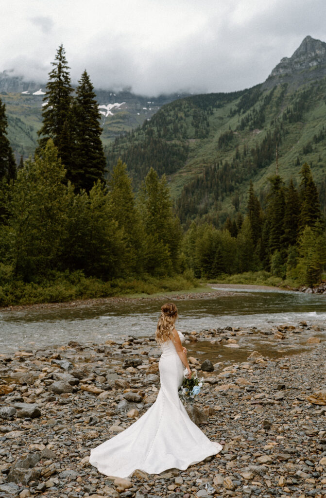 Bride looking at the mountains during an elopement at Glacier National Park