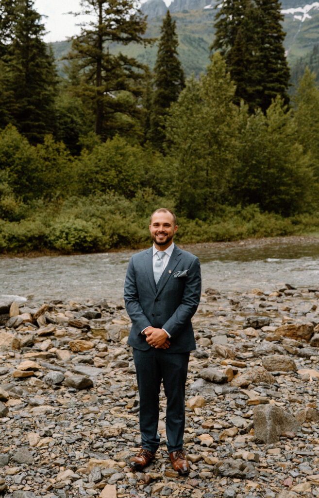 Groom smiling at the camera during an elopement in Glacier National Park