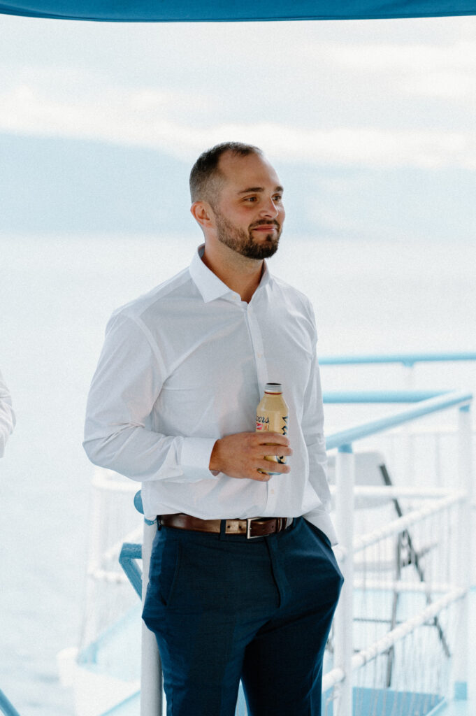 Groom smiling during speeches at rehearsal dinner in Montana