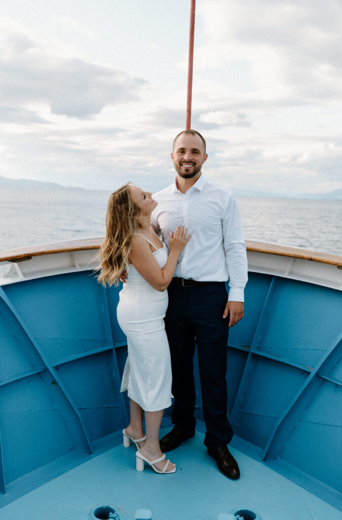 Bride and groom smiling on the boat during a rehearsal dinner in Montana