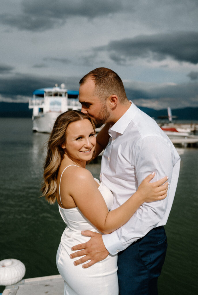 Groom kissing bride's forehead during their rehearsal dinner in Montana