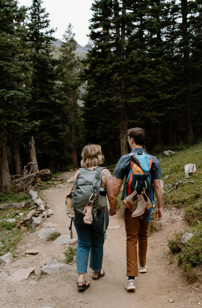 Couple backpacking during an engagement session at Lake Isabelle