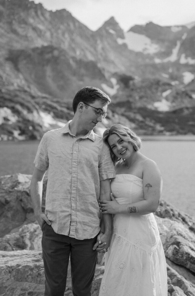 Fiancée smiling at the camera during an engagement session at Lake Isabelle