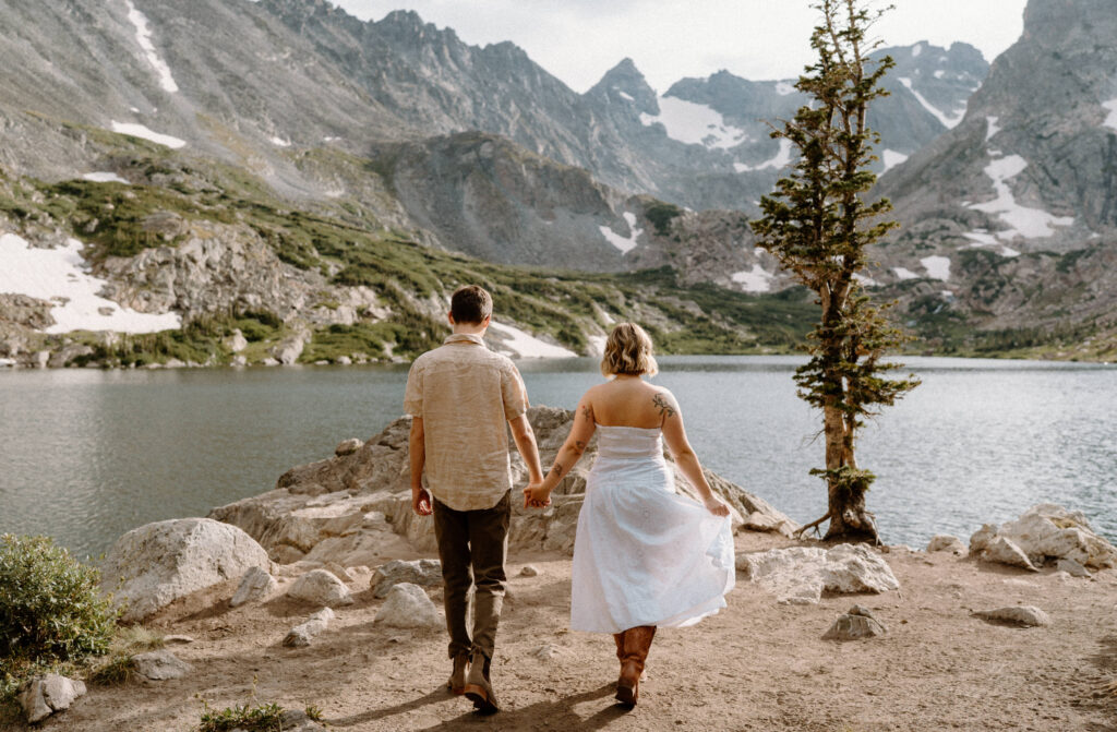 Couple walking on a path during an engagement session at Lake Isabelle