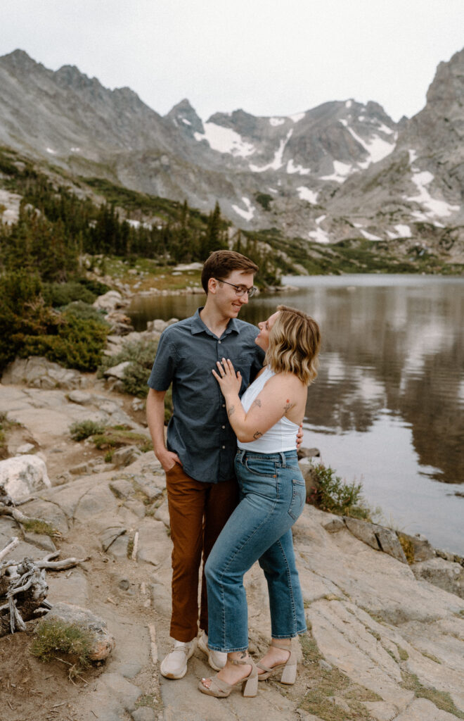 Couple smiling at Lake Isabelle during engagement session