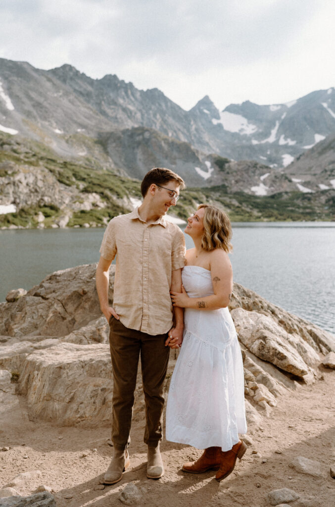 Couple smiling at each other during an engagement session at Lake Isabelle 