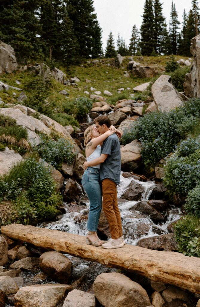 Couple kissing on a bride during an engagement session at Lake Isabelle