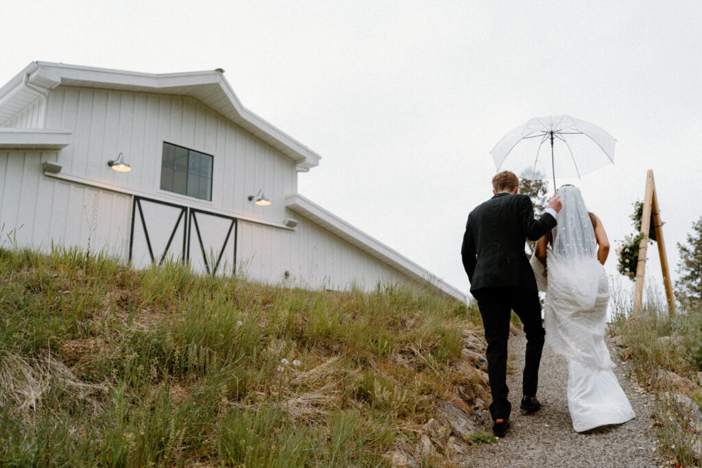 Bride and groom walking up a path on wedding day at Woodlands