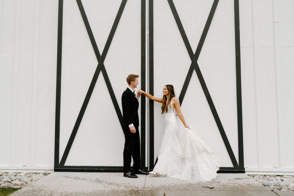 Bride and groom smiling outside of Woodlands on wedding day